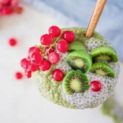 green matcha and chia pudding with baby kiwis and cranberries