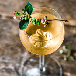 Gold drink with flower as garnish